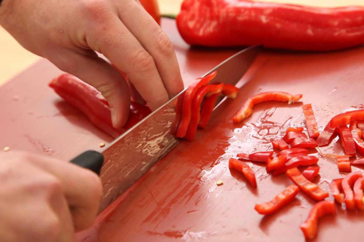 Professional cook school demonstrating knife skills during cooking course