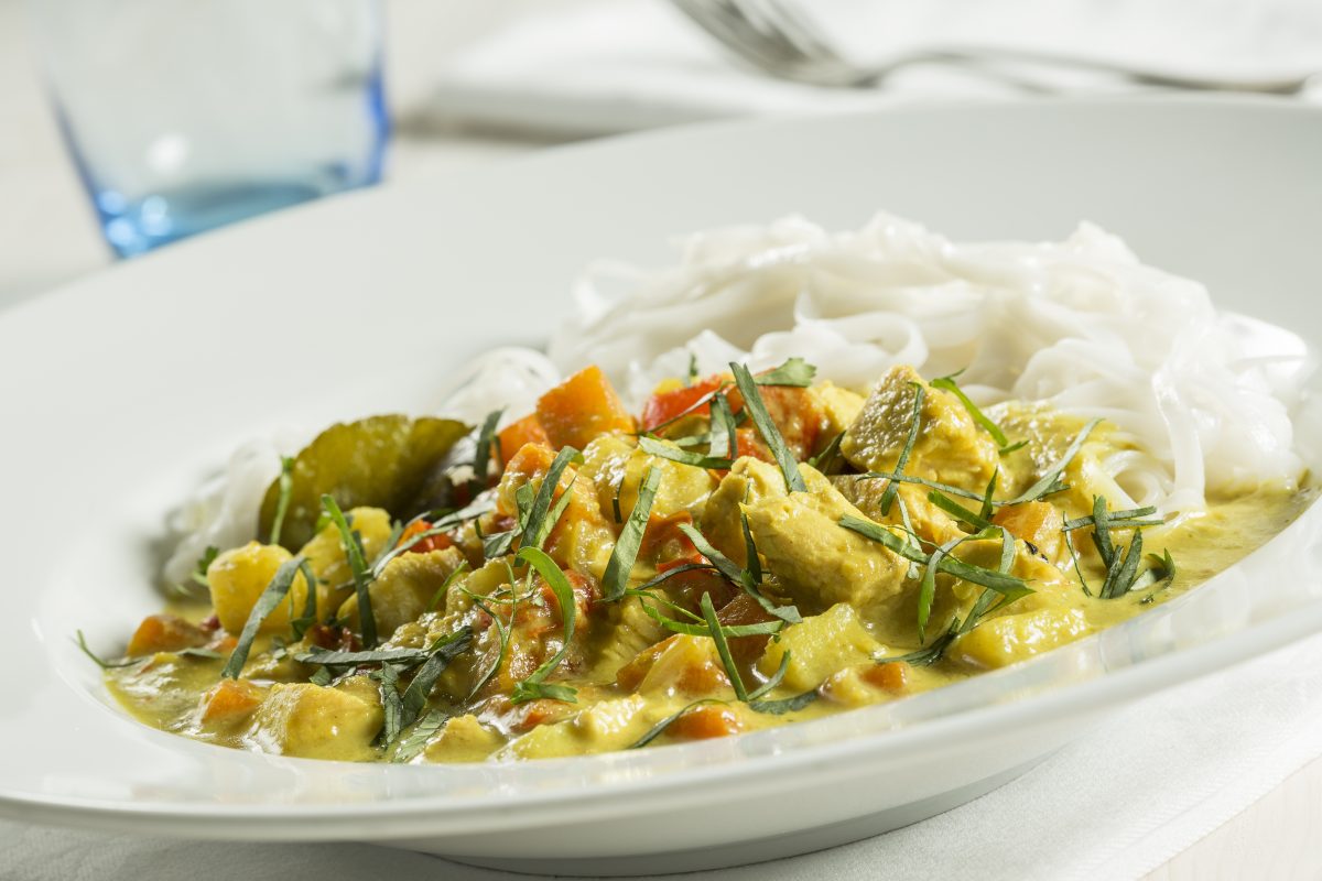 Cookery school students learning how to make curry