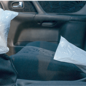 Disposable handbrake and gear stick covers fitted in car for interior protection