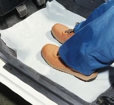 Large white disposable polythene floor mats 545x800mm used to protect vehicle carpets during automotive servicing